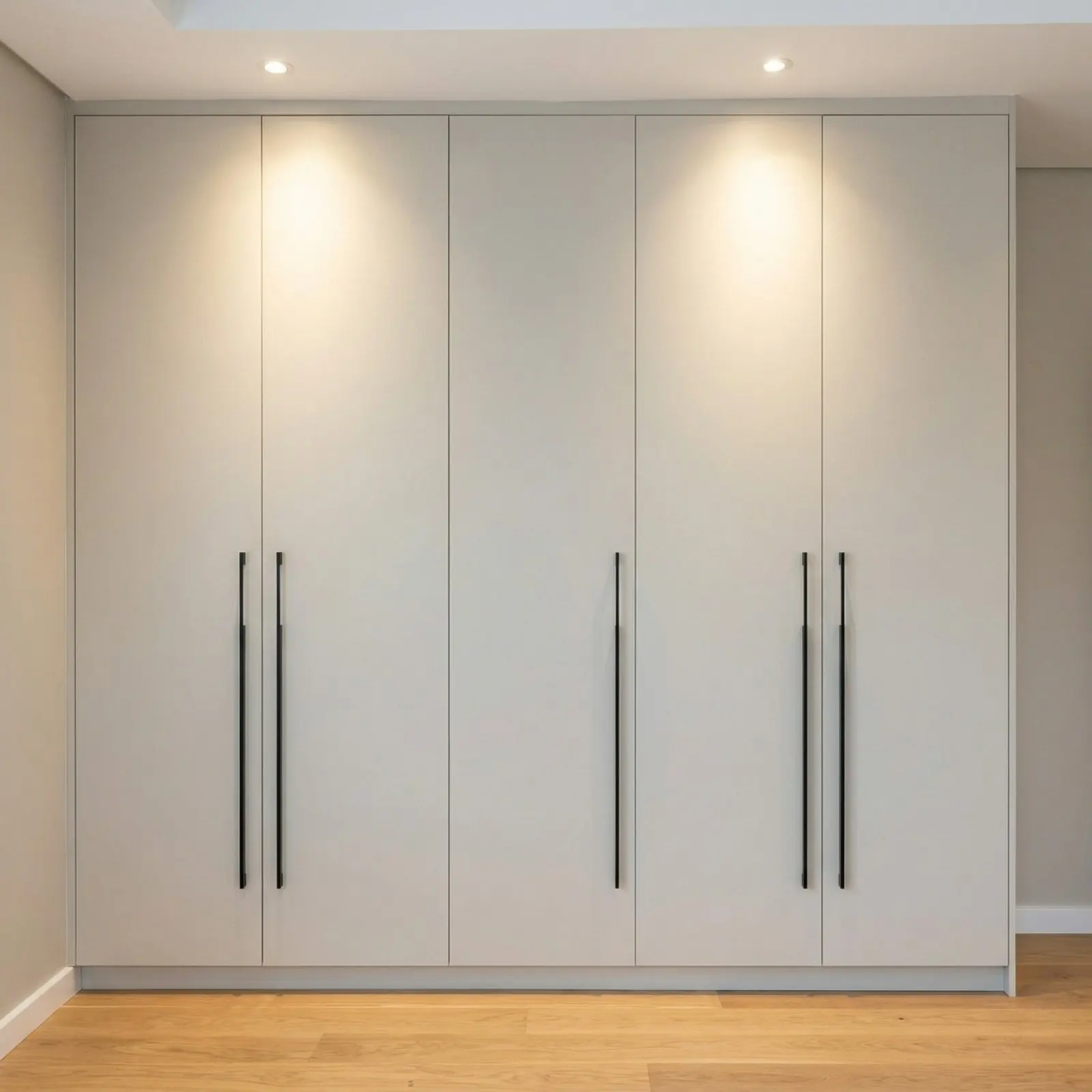 Light Grey Matte Five-Door Floor-to-Ceiling Wardrobe with Long Black Handles and Recessed Spotlights