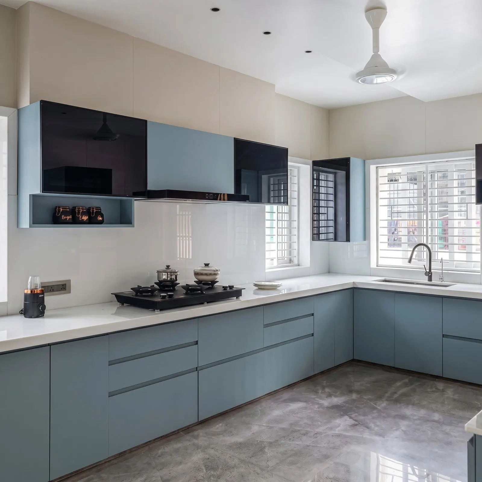 Slate Blue Matte L-Shaped Modular Kitchen with Black Gloss Upper Cabinets, White Quartz Countertop, Open Spice Shelf and Black Chimney Hood